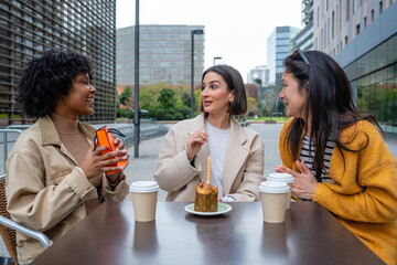 Friends celebrating birthday with gifts and coffee outdoors