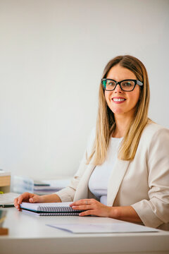 Professional woman smiling working in a modern office