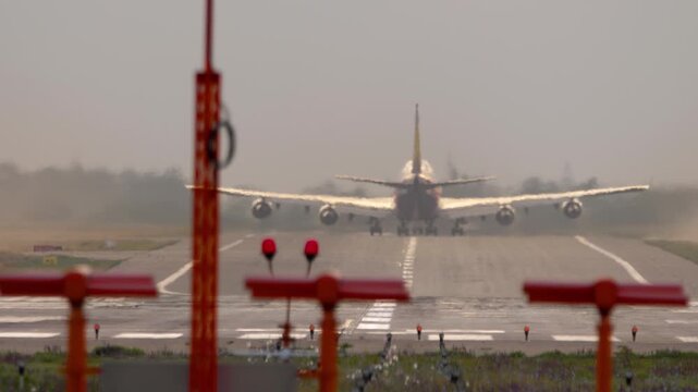 Footage heavy wide-body four-engine aircraft take off at sunrise or sunset backdrop. Aircraft departure