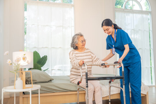 Caregiver assisting senior woman using walker at home, elderly mobility support and rehabilitation care, nursing service, physical therapy and recovery, helping improve independence and daily movement