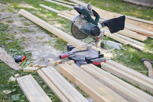 Painted boards on a miter saw outdoors