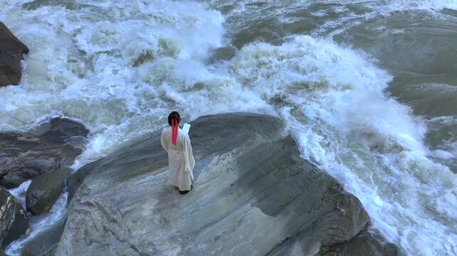 Ancient Chinese Scholar Meditating by Turbulent River in Traditional Hanfu。
Traditional Chinese Literati Reading and Contemplating by Rushing Water in Mountain Gorge