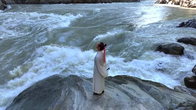 Ancient Chinese Scholar Meditating by Turbulent River in Traditional Hanfu。
Traditional Chinese Literati Reading and Contemplating by Rushing Water in Mountain Gorge