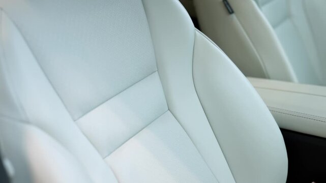 Leather seats in a modern car interior emphasize elegant design and comfort, emphasizing smooth texture and ergonomic shape.