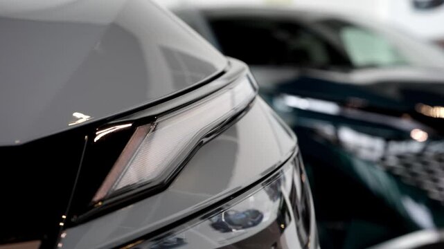 Modern car headlight detail with sleek design. Automotive styling concept.
