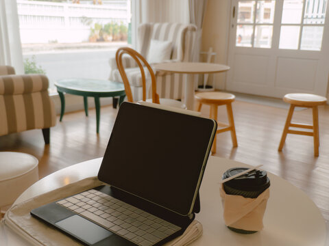 Cozy workspace scene. Quiet coffee shop with writing setup and sunlight