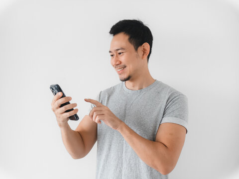 Smiling male figure connecting with smartphone in inviting setting