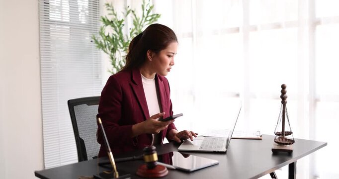 Female lawyer looking stressed using smartphone in office