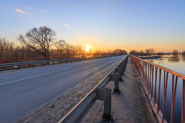 Fototapeta premium Sunset glows over quiet bridge