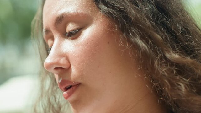 Closeup woman face near palms, beachside blogger filming candid clip on island shore, gentle breeze, sun shimmer on skin, relaxed smile, tropical warmth, vacation vibe, candid framing