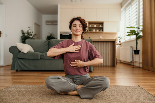 Woman practicing deep breathing exercise for mindfulness at home
