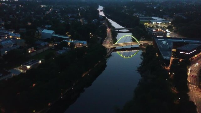 Aerial night shot of city light reflections on the calm Emajogi river surface in Tartu.