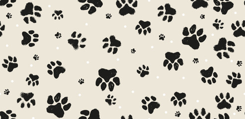 Fototapeta premium Seamless pattern with black paw prints on beige background. Cute animal footprint vector illustration for pet shop branding, wallpaper, fabric, wrapping paper, and textile design. Seamless pattern paw