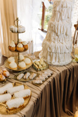 Fototapeta premium Elegant dessert table with a tiered cake and assorted pastries for a celebration