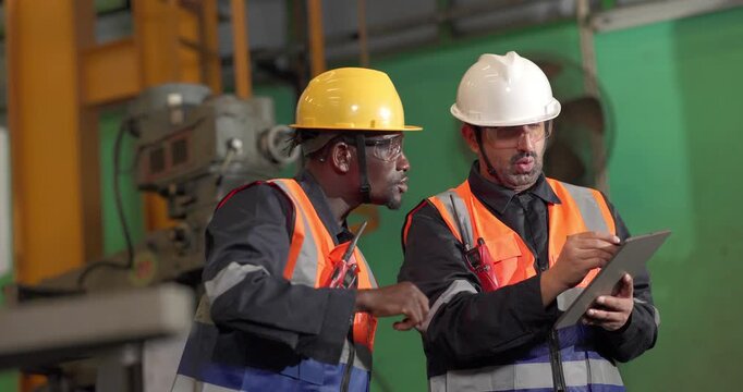 A supervisor mentors a technician using a rugged laptop beside a production machine in a manufacturing facility, showing digital supervision, faster troubleshooting, productivity, and process control.