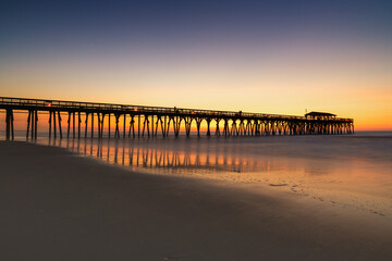 view of the historic Myrtle Beach State Park wooden pier at sunrise © makasana photo