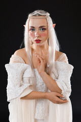 Naklejka premium Portrait of beautiful elf girl on black background