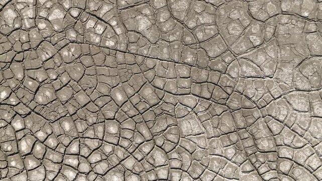 Aerial view of intricate cracked earth patterns and dry mud texture in Minas de Riotinto, Andalusia, Spain.
