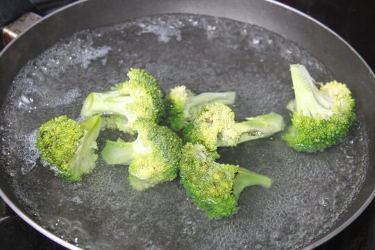 Fresh Green Broccoli Florets Boiling in Hot Water Pan