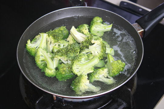 Fresh Green Broccoli Florets Boiling In Pan Of Hot Water