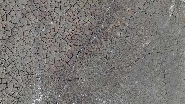 Aerial view of the intricate patterns of cracked dry earth and mineral deposits in the mining landscape of Minas de Riotinto, Andalusia, Spain.
