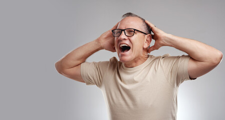 Naklejka premium Mature, man and excited in studio with shock, notification or announcement for winner of lottery prize. Space, person and happy with surprise, open mouth or good news for giveaway on white background