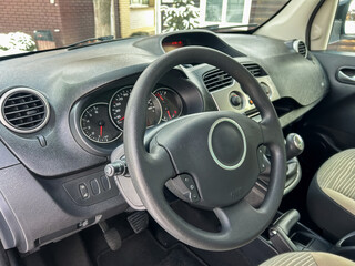 Fototapeta premium Car interior shows steering wheel and dashboard with controls in a parked vehicle during winter season