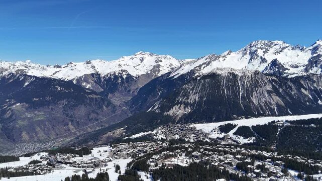 Aerial panaromic view of Courchevel 1850, ski resort 1650 and Bozel between snowy mountains.