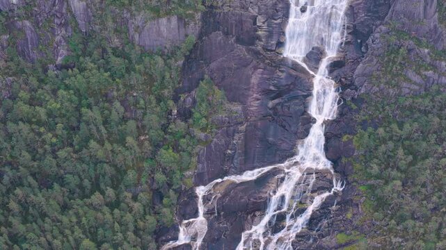 Rising by waterfall Langfoss Norway 