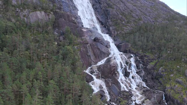 Rising by waterfall Langfoss Norway 