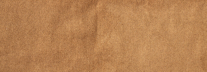 Brown suede leather texture background with soft velvet surface and natural fabric fiber details