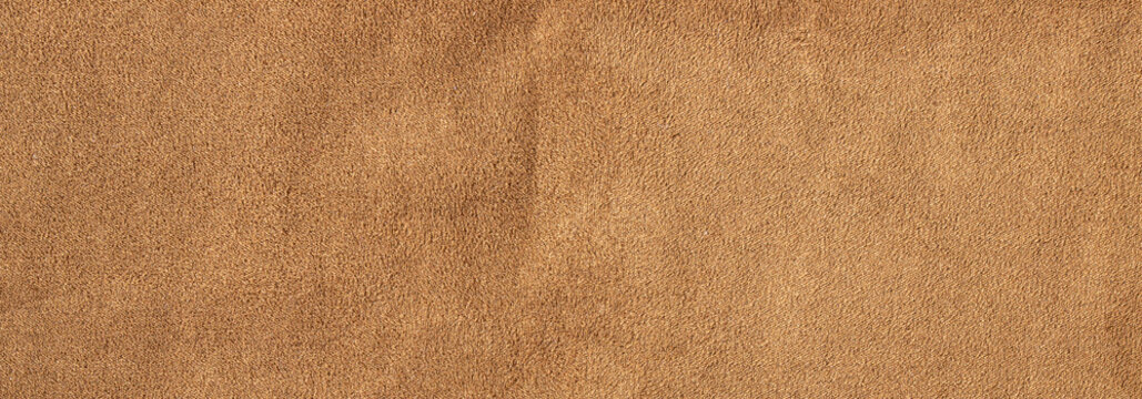 Brown suede leather texture background with soft velvet surface and natural fabric fiber details
