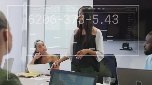Standing meeting lead starting business brief, gesturing, making HUD over laptops obscuring people