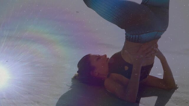 Woman lifting into shoulderstand, initiating hip lift, stabilizing core for yoga, rainbow halo