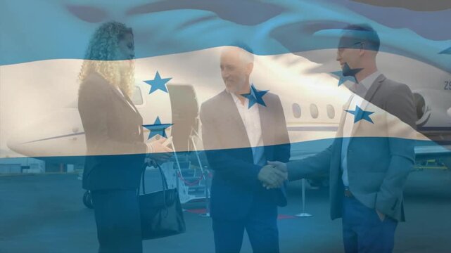 Business team greeting on jet ramp, arrival sparking handshakes, flag overlay veiling group