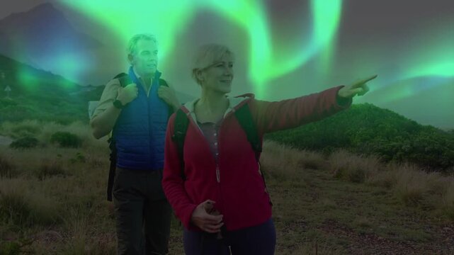 Vertical video: Seeing aurora, stopping pair red jacket blue vest on trail holding bottle and packs