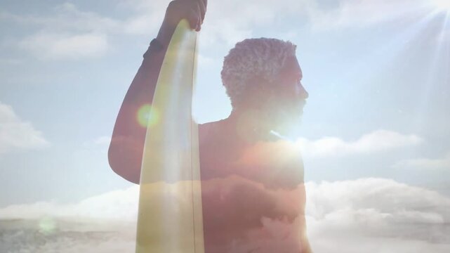 Male surfer holding surfboard scanning horizon after spotting wave, animated flares following gaze