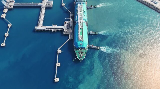 LNG (Liquified Natural Gas) tanker anchored in Gas terminal gas tanks for storage. Oil Crude Gas Tanker Ship. LPG at Tanker Bay Petroleum Chemical or Methane freighter export import transportation