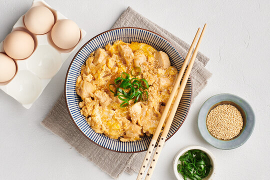 Oyakodon, traditional Japanese meal with chicken and egg, comfort food, flat lay