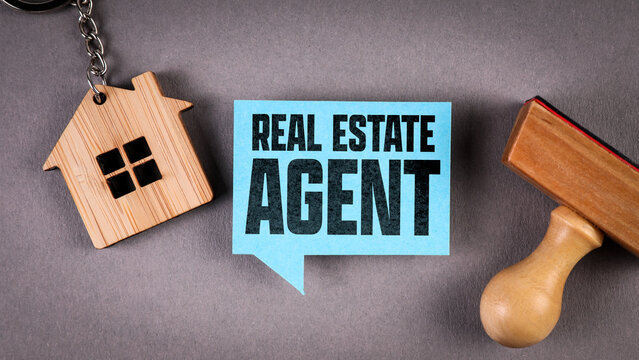 Real Estate Agent Concept with House Keychain and Stamp on Desk