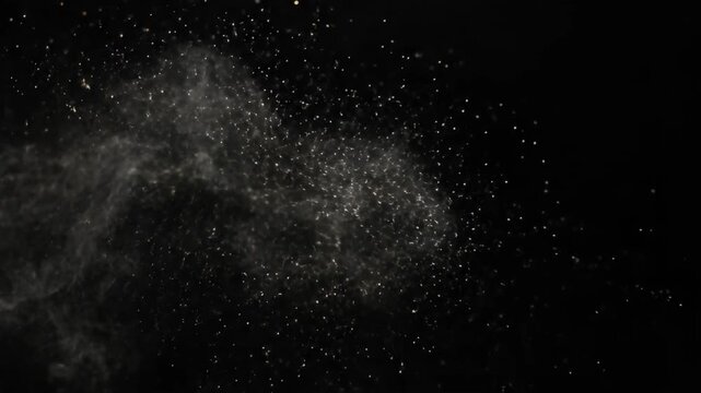White particles and smoke scattering on a dark background