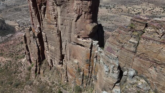 Aerial view of the Gheralta range in northern Ethiopia, with dramatic cliffs and isolated plateaus stretching across Tigray. Revealing drone footage.