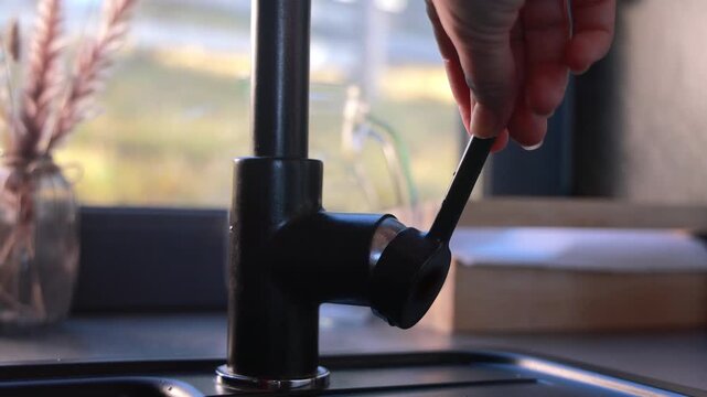 Close-up portrait of an emotional rock singer in a black shirt performing live, man with long hair and beard singing passionately inside industrial factory