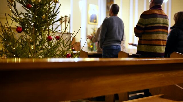 Congregation gathering for Christmas mass service in a Catholic Church