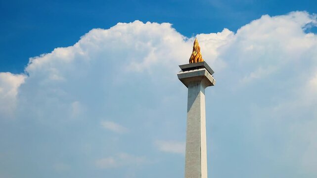Jakarta, Indonesia - April 2, 2026: Timelapse of Monas or National Monument standing with clear sky. National Monument is Jakarta's famous landmark.