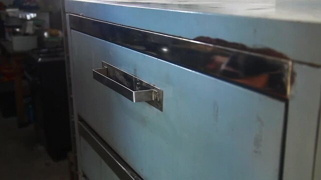 Video of raw chocolate chip cookies being placed in the oven.