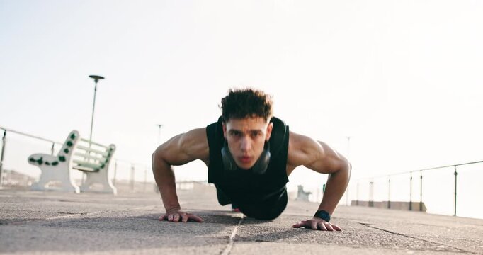 Push up, fitness and man in city, face and exercise for wellness, challenge and low angle. Outdoor, person and athlete in street, performance and training for endurance, balance and cardio workout