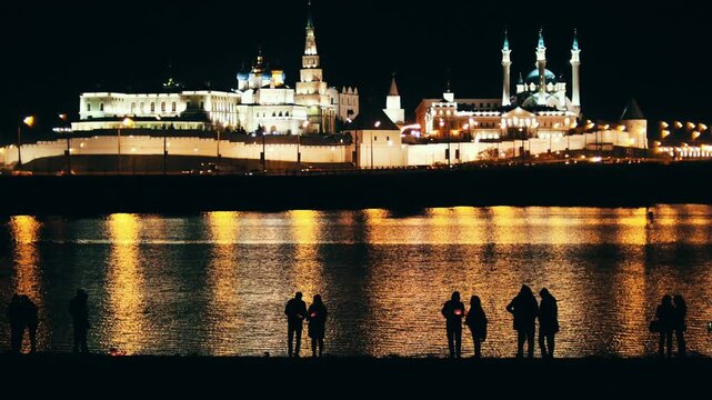 People silhouettes standing at kazan kremlin night view