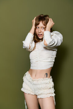 Stylish young woman exudes confidence in trendy attire against a vibrant backdrop