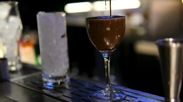 Bartender preparing coffee alcoholic drink glass with ice bar European nightlife cocktail beverage